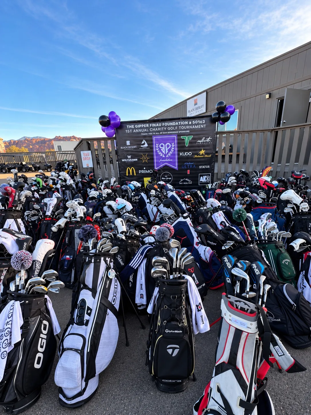 Rows of golf bags in front of a Foundation fundraiser backdrop